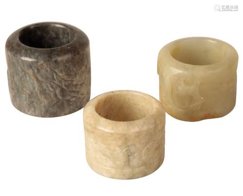 THREE CARVED JADE ARCHERS RINGS