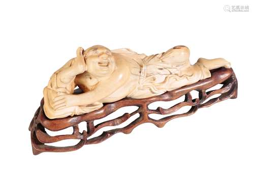 CARVED IVORY FIGURE OF A RECLINING BUDDHA