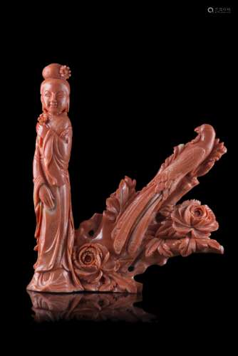 A red coral carving of a standing lady flanked by a peacock perched on a branch (defects)China,