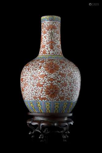A porcelain vase decorated with floral and auspicious motifs on an orange-ground, wood baseChina,