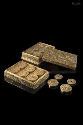 A fine gilt bronze box composed by two pliable trays, each with twelve auspicious coins, decorated