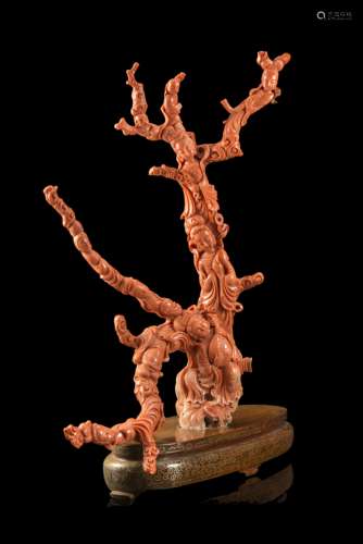 A large coral branch carved with elegant ladies carrying musical instruments and flowering