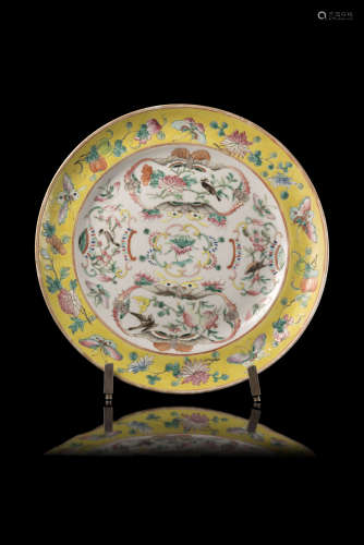 A yellow-ground Famille Rose dish decorated with birds, flowers and Buddhist parasols, with