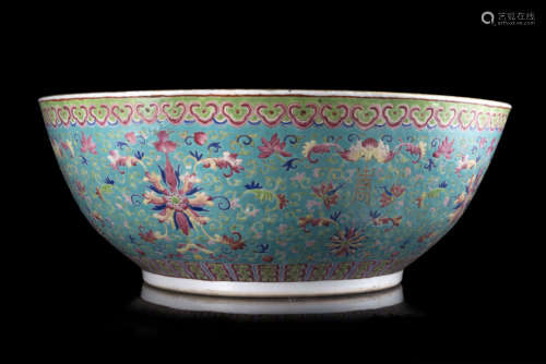 A porcelain fish bowl decorated to the exterior with floral motifs in Famille Rose on a turquoise