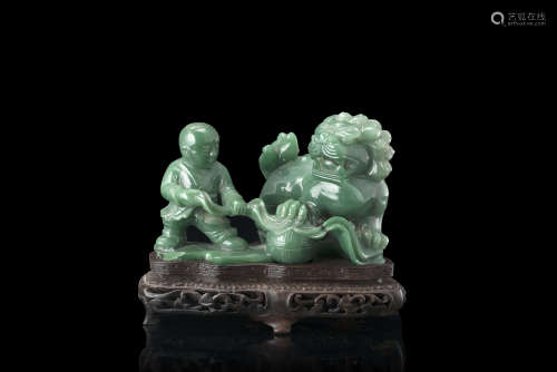 A green jadeite sculpture of children at play with a Buddhist lion, with wood baseChina, 19th