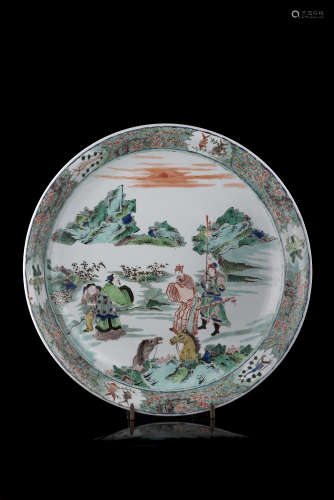 A large Famille Verte dish decorated with figures and horses in a mountain landscapeChina, 20th
