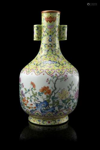 An arrow-head vase with twin tubular handles decorated in lime-green Famille Rose enamels with a