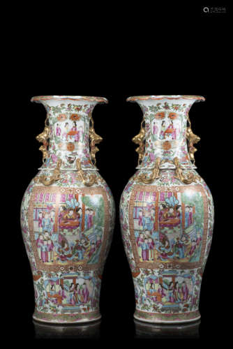 A pair of Cantonese Famille Rose vases decorated with figures in interior scenes and floral