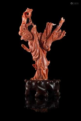 A red coral carving of a lady wearing long robes accompanied by a phoenix, wood baseChina, early