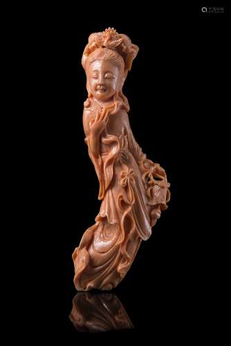 A small coral carving of a lady carrying a lanternChina, early 20th century(h. 13.5 cm.; net