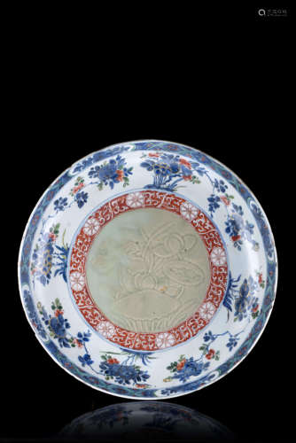 A blue and white and iron red enamelled dish, the centre with a celadon glaze, decorated with floral