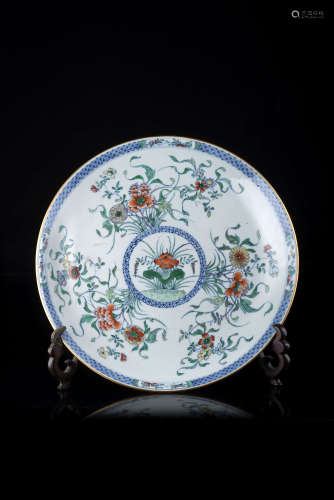 A doucai dish, decorated with flowers and geometric motifs, wood base (defects)China, 19th century(