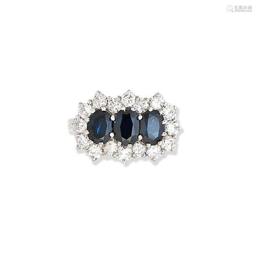 A three-stone sapphire and diamond ring