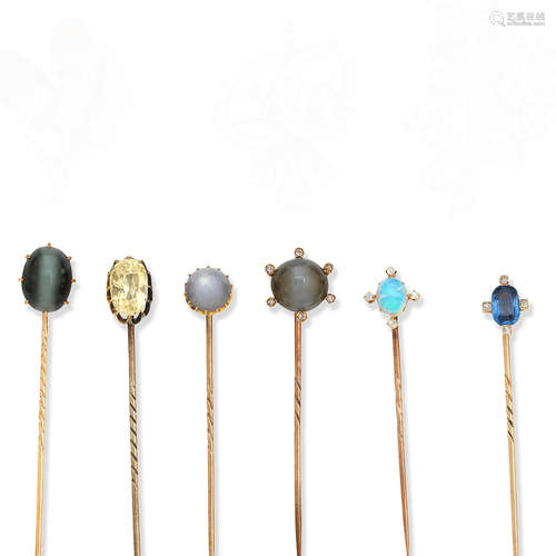 A collection of stickpins, including two set with coloured sapphires