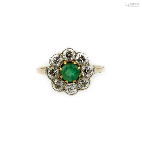 An emerald and diamond cluster ring