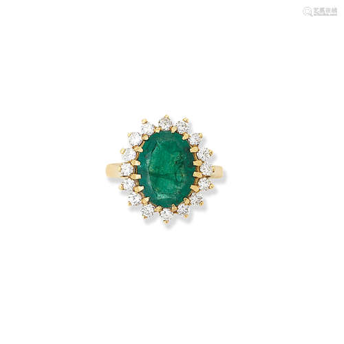 An emerald and diamond cluster ring