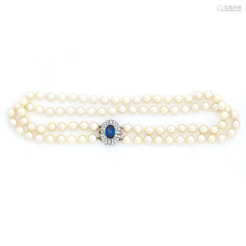 A cultured pearl necklace with a synthetic sapphire and diamond clasp