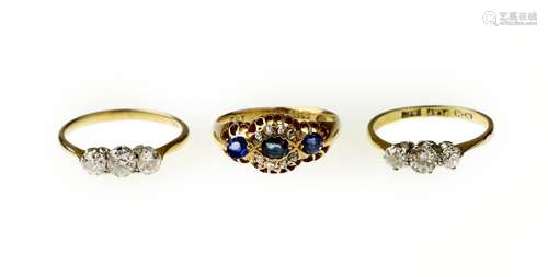 Two three-stone diamond rings and a sapphire and diamond ring