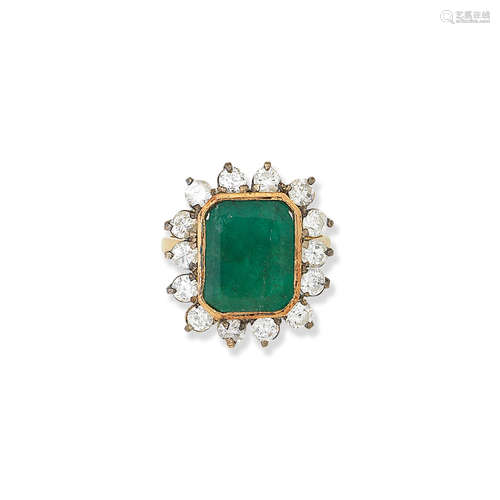 An emerald and diamond cluster ring