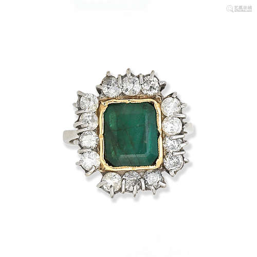 An emerald and diamond cluster ring