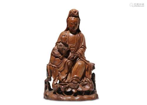 A CHINESE NANMU FIGURE OF GUANYIN AND CHILD.