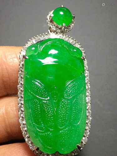 A TRANSLUCENT JADEITE ZHENGYANG GREEN CICADA PENDANT