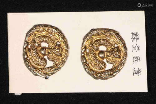 TWO DRAGON SHAPED EMBLEMS