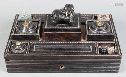 Continental ebonized desk tray, having an elephant form finial, centering the fitted top with