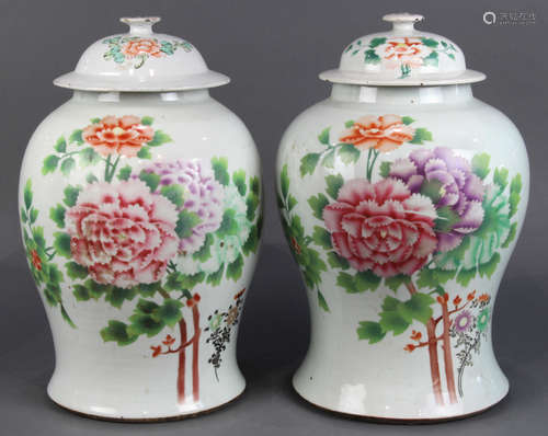 Pair of Chinese enameled porcelain lidded jars, decorated with peonies accented by leafy branches,