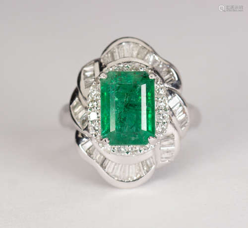 Emerald, diamond and platinum ring Centering (1) emerald-cut emerald, weighing approximately 2.75