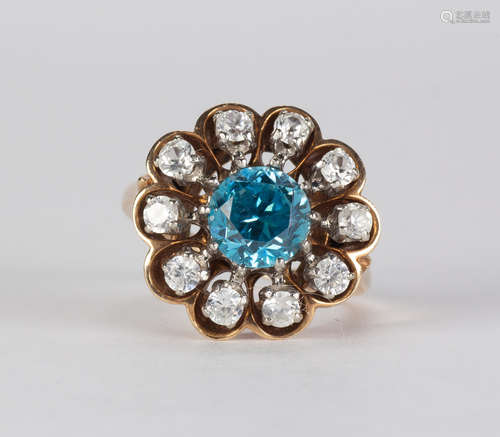 Blue zircon, diamond and 10k yellow gold ring Centering (1) round-cut blue zircon, weighing