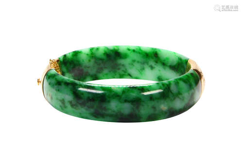 Jadeite and 14k yellow gold bracelet Featuring (2) carved jadeite segments, measuring