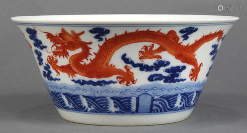 Chinese porcelain bowl, with flared walls decorated with meandering red-orange dragons amid