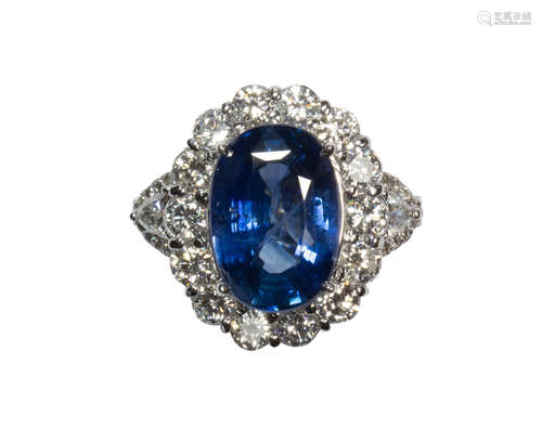 Sapphire, diamond and 18k white gold ring Centering (1) oval-cut sapphire, weighing 5.78 cts.,