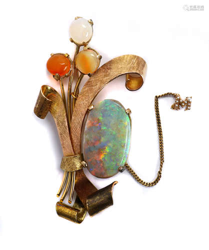 Opal and yellow gold brooch Featuring (1) oval boulder opal, measuring approximately 28.4 X 16.7 X