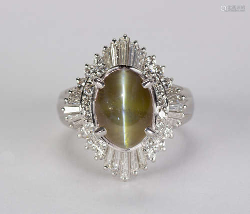 Cat's eye chrysoberyl, diamond and platinum ring Centering (1) oval cat's eye chrysoberyl,