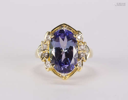 Tanzanite, diamond and 18k yellow gold ring Centering (1) oval-cut tanzanite, weighing approximately