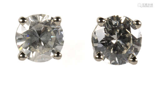 Pair of diamond and 14k white gold earrings Featuring (2) round brilliant-cut diamonds, weighing a