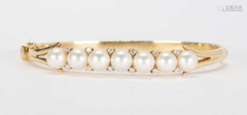 Cultured pearl, diamond and 18k yellow gold bracelet Featuring (7) 7.0 mm, cultured pearls, accented