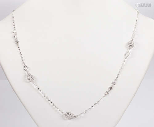 Diamond and 18k white gold necklace Designed with varying shaped, drop, filigree beads, accented