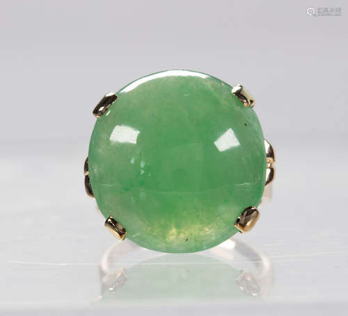 Jadeite and 14k yellow gold ring Featuring (1) round jadeite cabochon, weighing 20.36 cts.,