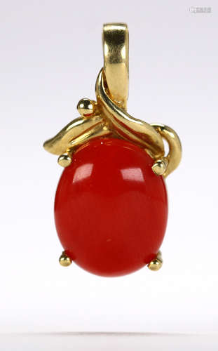 Coral and 14k yellow gold pendant Featuring (1) oval coral cabochon, measuring approximately 10.0