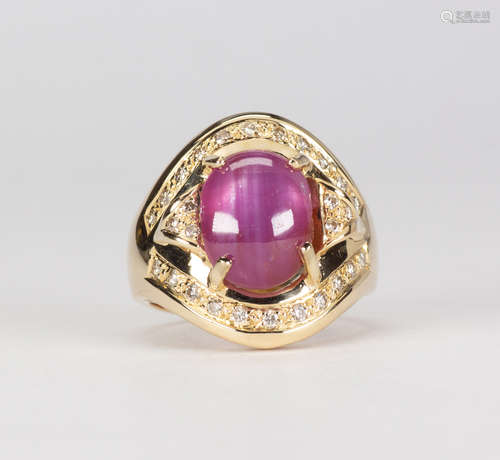 Ruby, diamond and 14k yellow gold ring Centering (1) oval ruby cabochon, weighing 8.43 cts.,