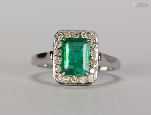 Emerald, diamond and 14k white gold ring Featuring (1) emerald-cut emerald, weighing approximately