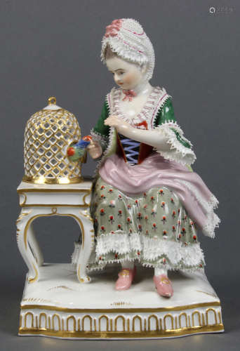 Meissen porcelain figural group, depicting a woman seated by a bird, underside with blue cross