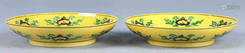 Pair of Chinese porcelain plates, featuring a green dragon and aubergine phoenix in the center,