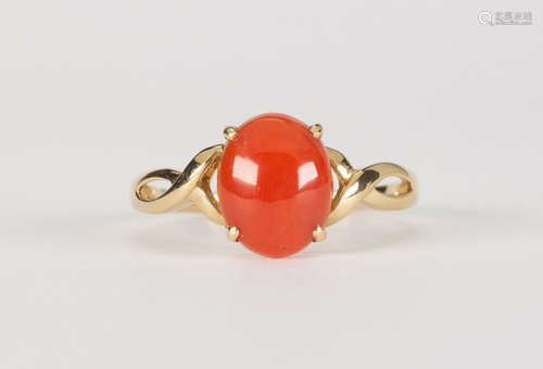 Coral and 14k yellow gold ring Centering (1) oval coral cabochon, measuring approximately 9.75 X 8.