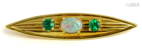 Opal, emerald and yellow gold brooch Centering (1) oval opal cabochon, measuring approximately 9 X