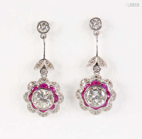 Pair of diamond, ruby and platinum earrings Featuring (2) round brilliant-cut diamonds, weighing a