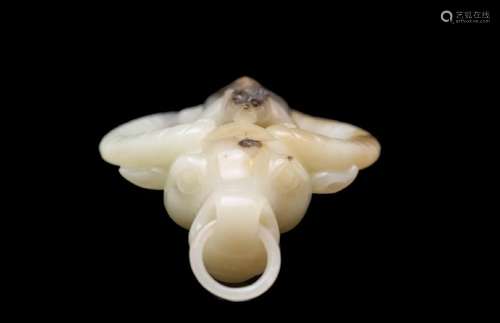 A CARVED WHITE JADE OX AND MONKEY PENDANT.